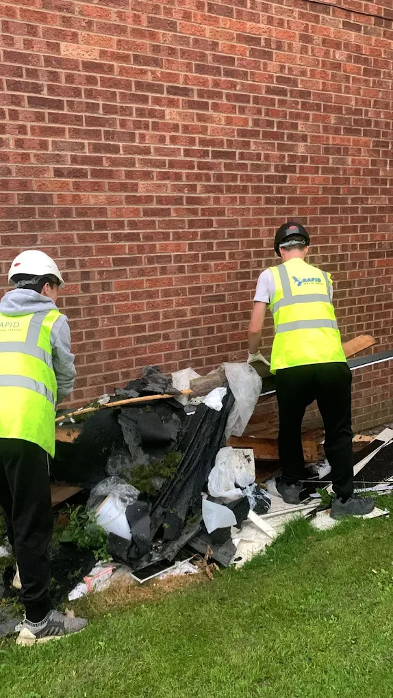 Rapid Waste Removal team clearing builders' waste against a brick wall