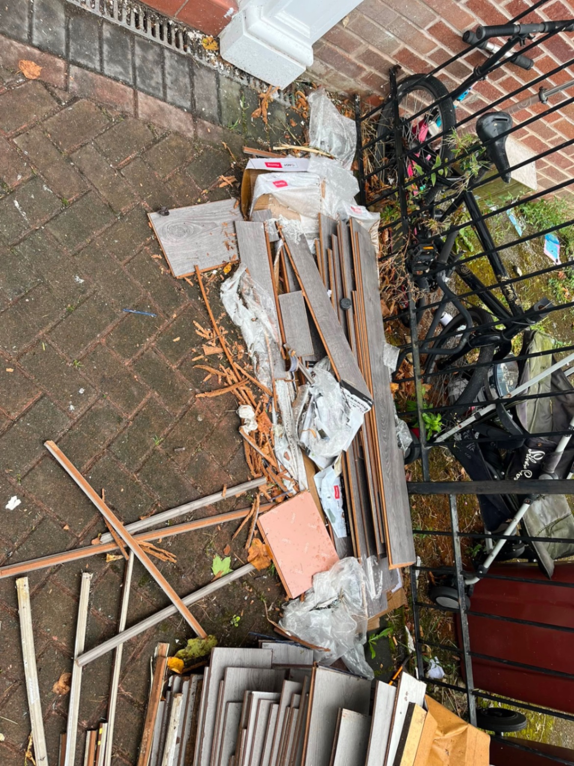 Yard piled with timber and waste before clearance